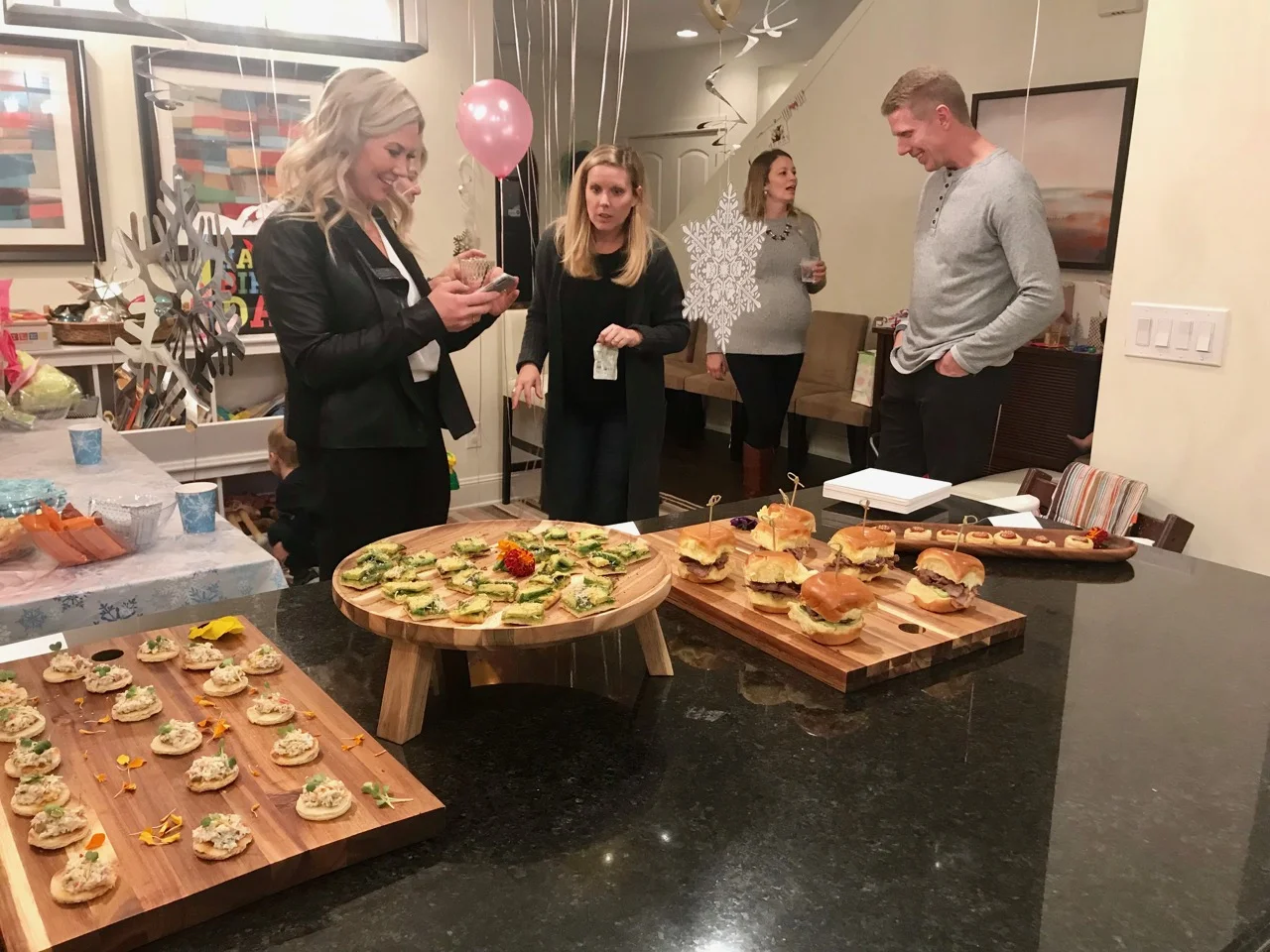 Guests socializing around a catered food display from XIM's website
