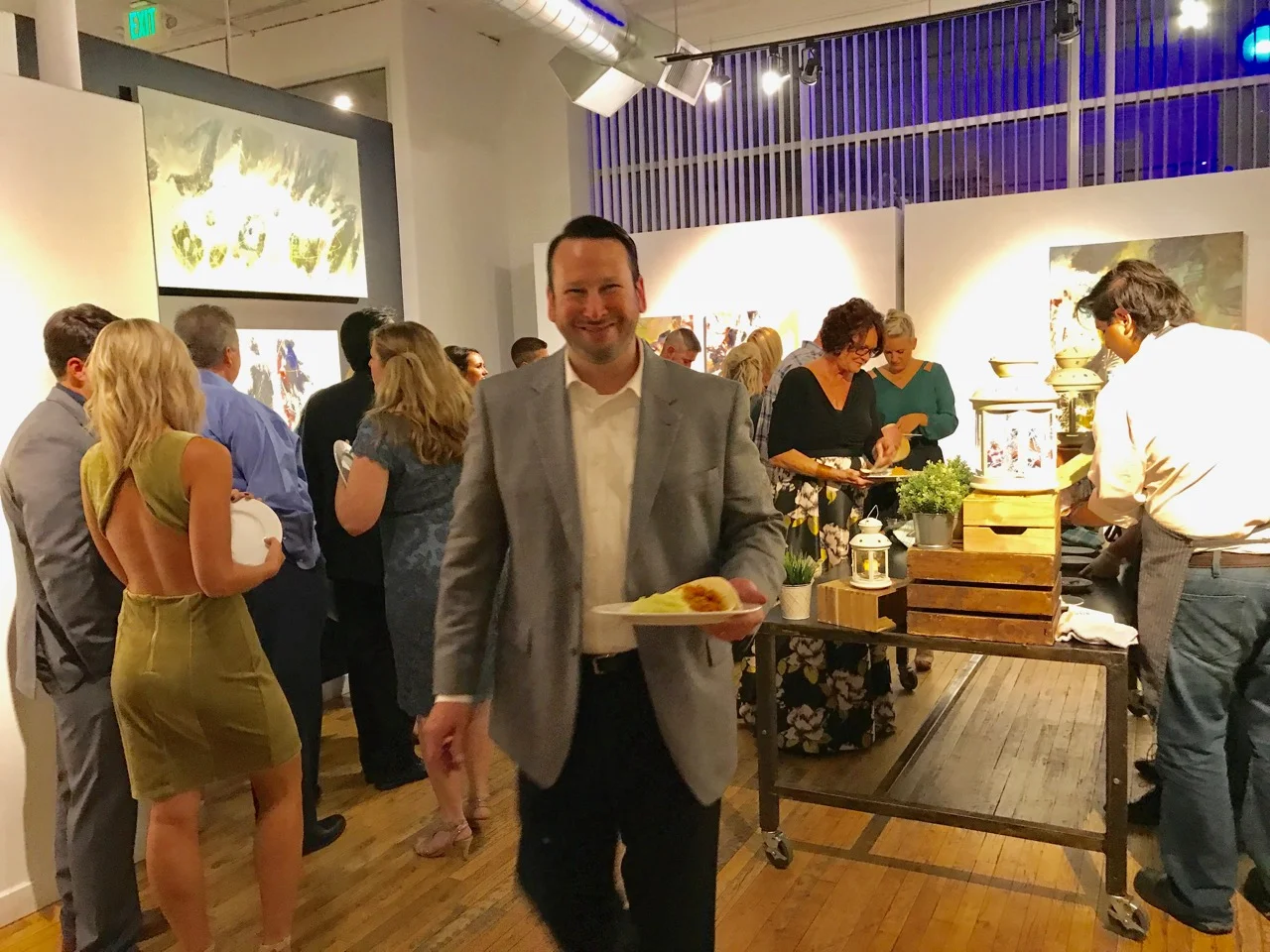 Smiling guests enjoying a catered celebration from XIM's website