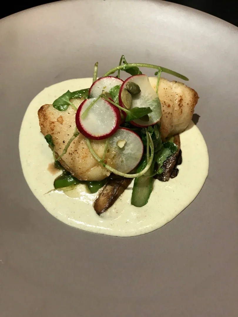 XIM halibut with greens and sliced vegetables