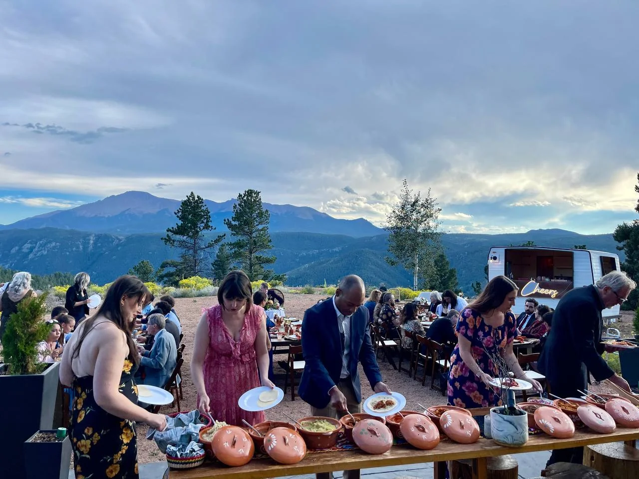 Guests enjoying a taco bar at a mountain celebration