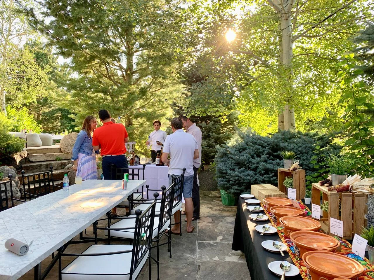 Taco bar set for a gathering on a tree-lined patio