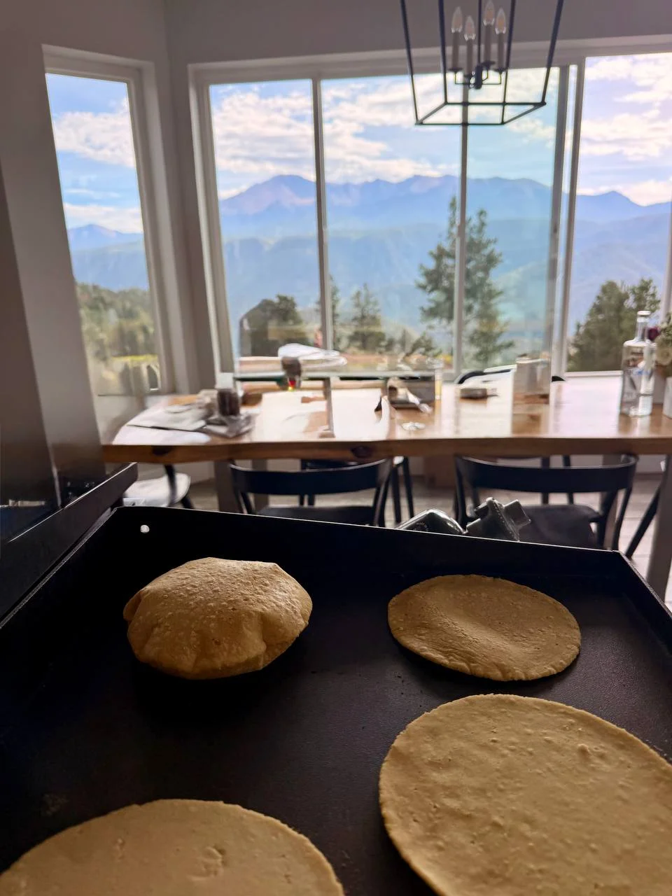 Handmade corn tortillas puffing on the grill